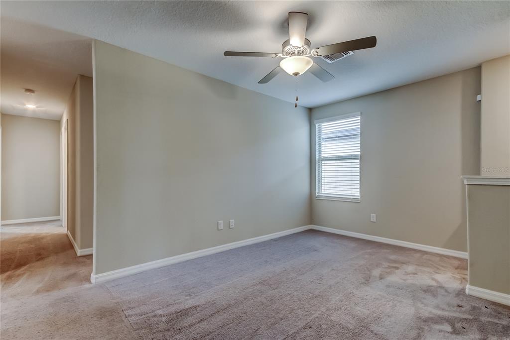 31592 Barrel Wave Way Wesley Chapel, FL 33545 - Photo 30 of 62 an empty room with windows and fan