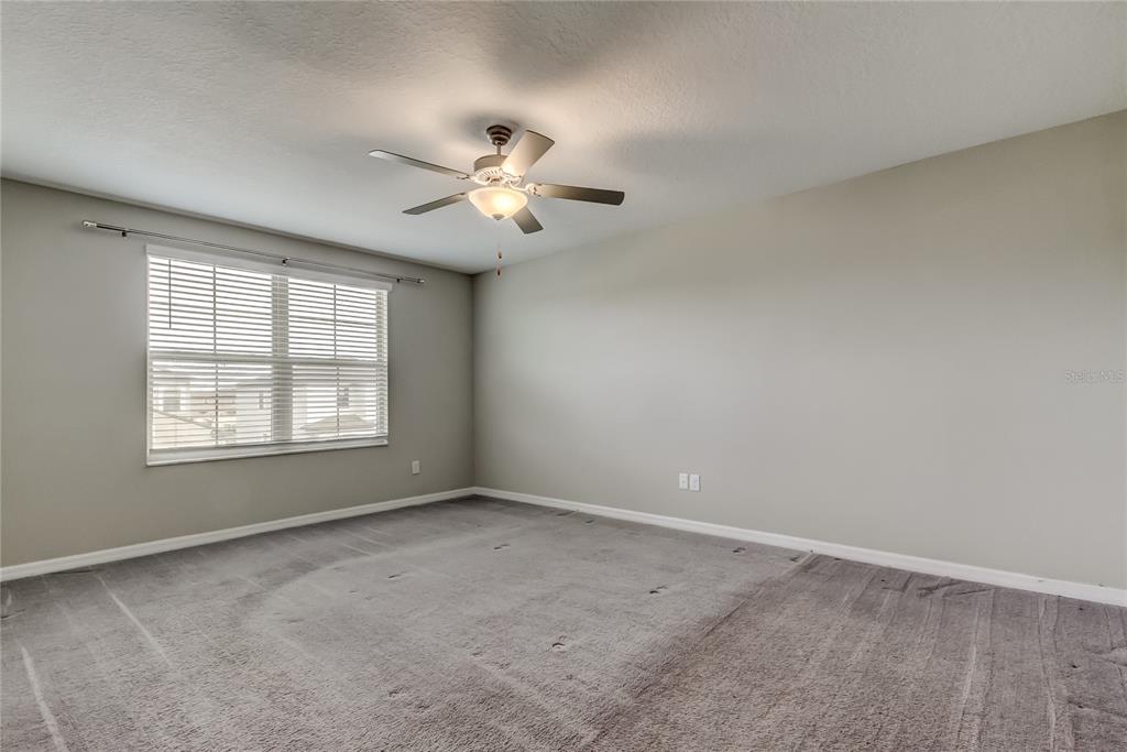 31592 Barrel Wave Way Wesley Chapel, FL 33545 - Photo 33 of 62 wooden floor in an empty room with a window