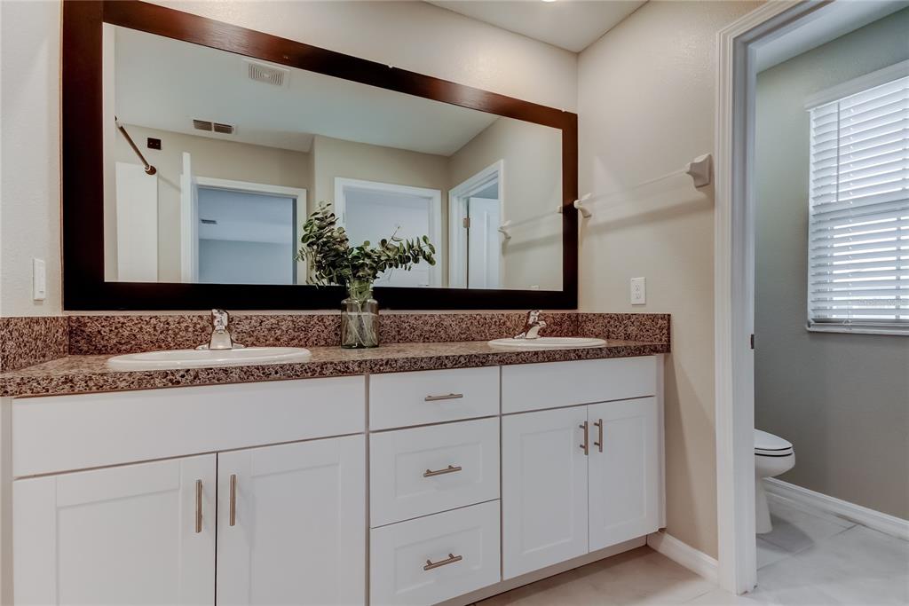 31592 Barrel Wave Way Wesley Chapel, FL 33545 - Photo 37 of 62 a bathroom with a sink and a mirror