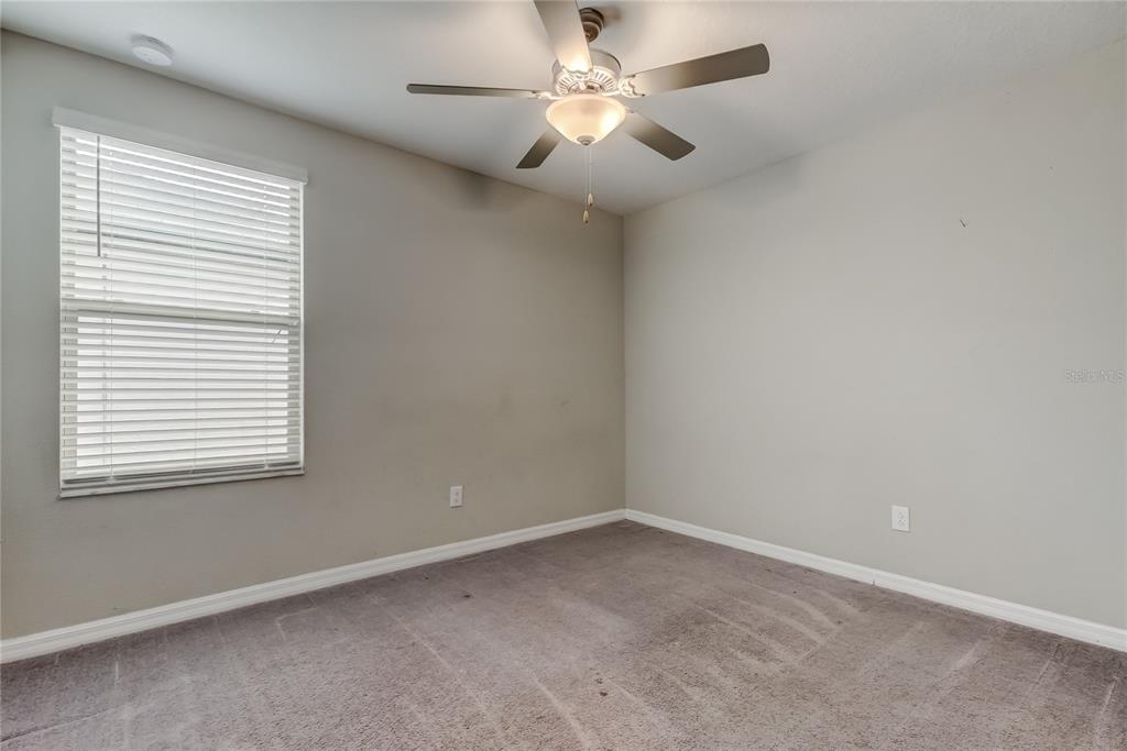 31592 Barrel Wave Way Wesley Chapel, FL 33545 - Photo 44 of 62 an empty room with a window and a fan
