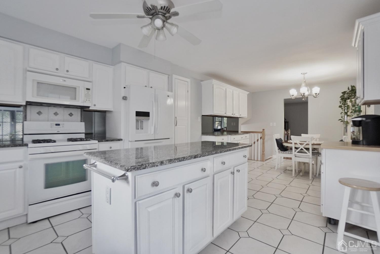 60 Annette Drive Edison, NJ 08820 - Photo 30 of 69 a kitchen with white cabinets and appliances