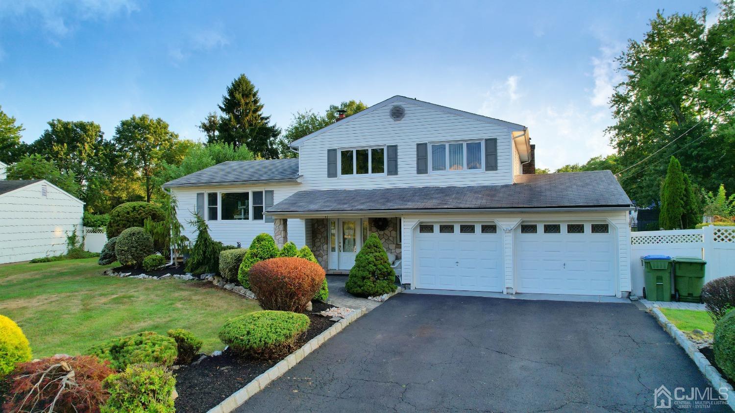 60 Annette Drive Edison, NJ 08820 - Photo 3 of 69 a front view of a house with a yard and garage