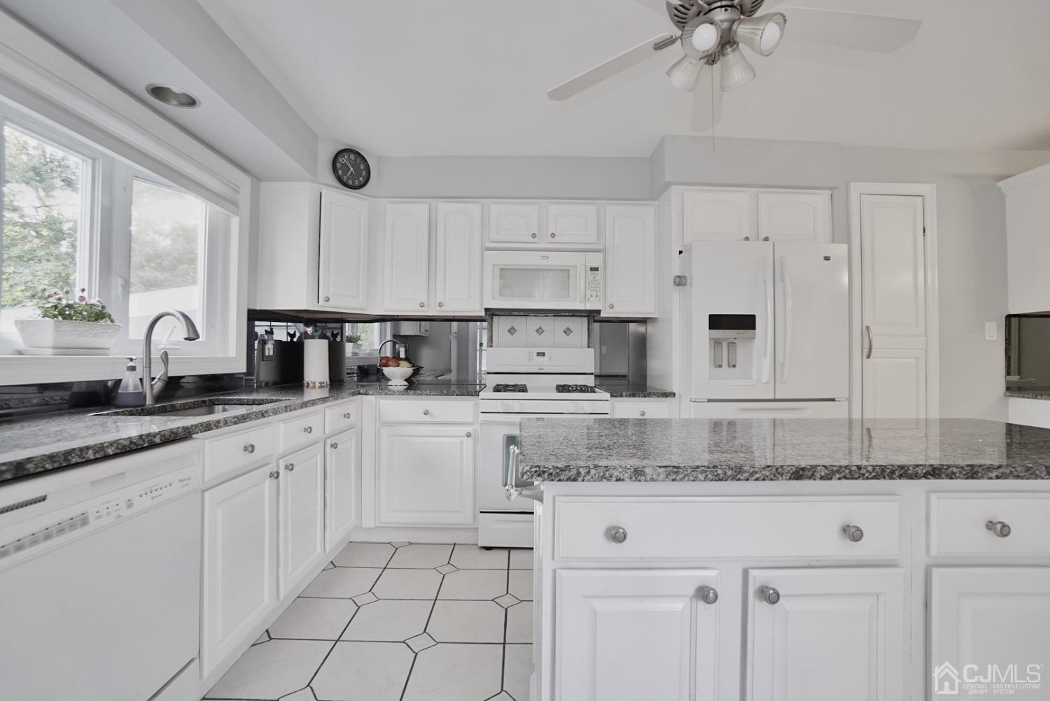 60 Annette Drive Edison, NJ 08820 - Photo 31 of 69 a kitchen with granite countertop white cabinets white appliances with a sink and a window