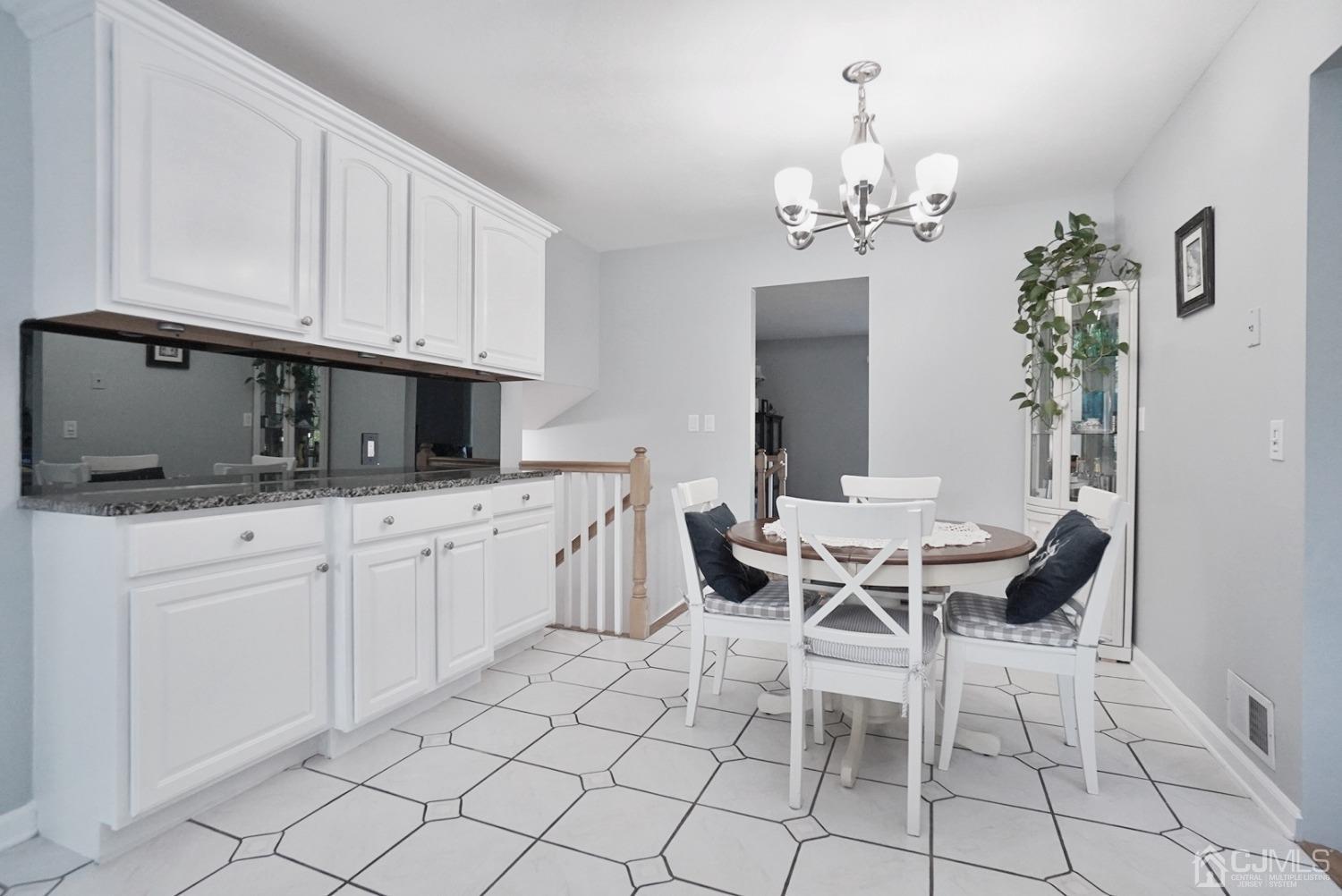 60 Annette Drive Edison, NJ 08820 - Photo 34 of 69 a view of a dining room with furniture and chandelier