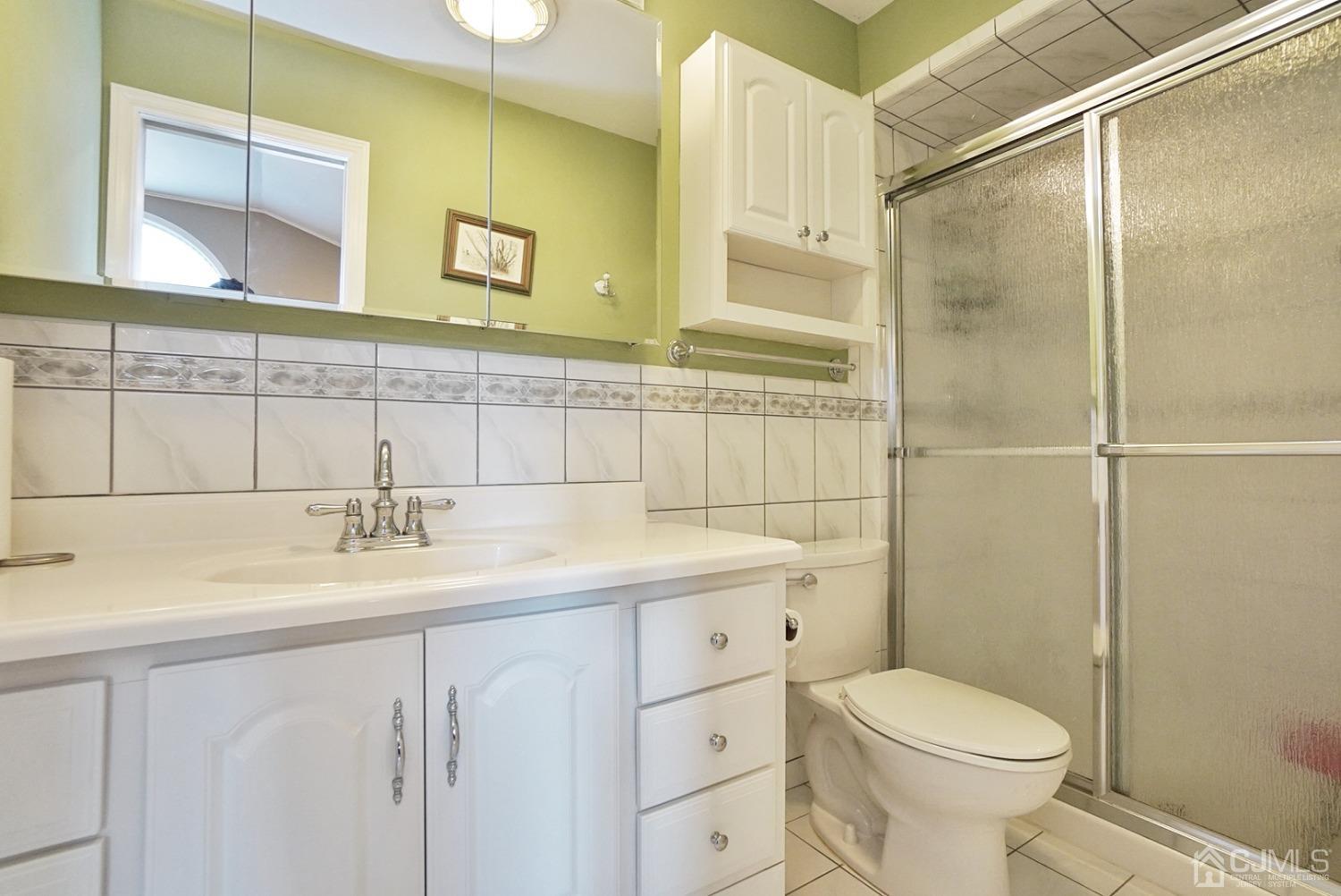 60 Annette Drive Edison, NJ 08820 - Photo 50 of 69 a bathroom with a sink a toilet and shower