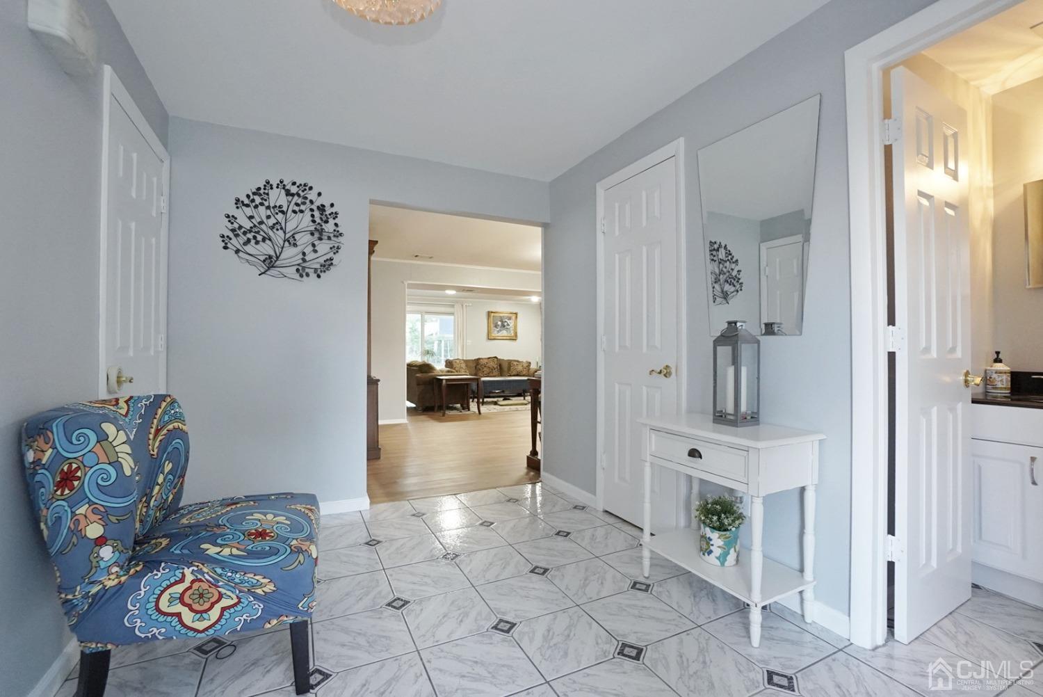 60 Annette Drive Edison, NJ 08820 - Photo 5 of 69 a hallway with a dining table and a couch