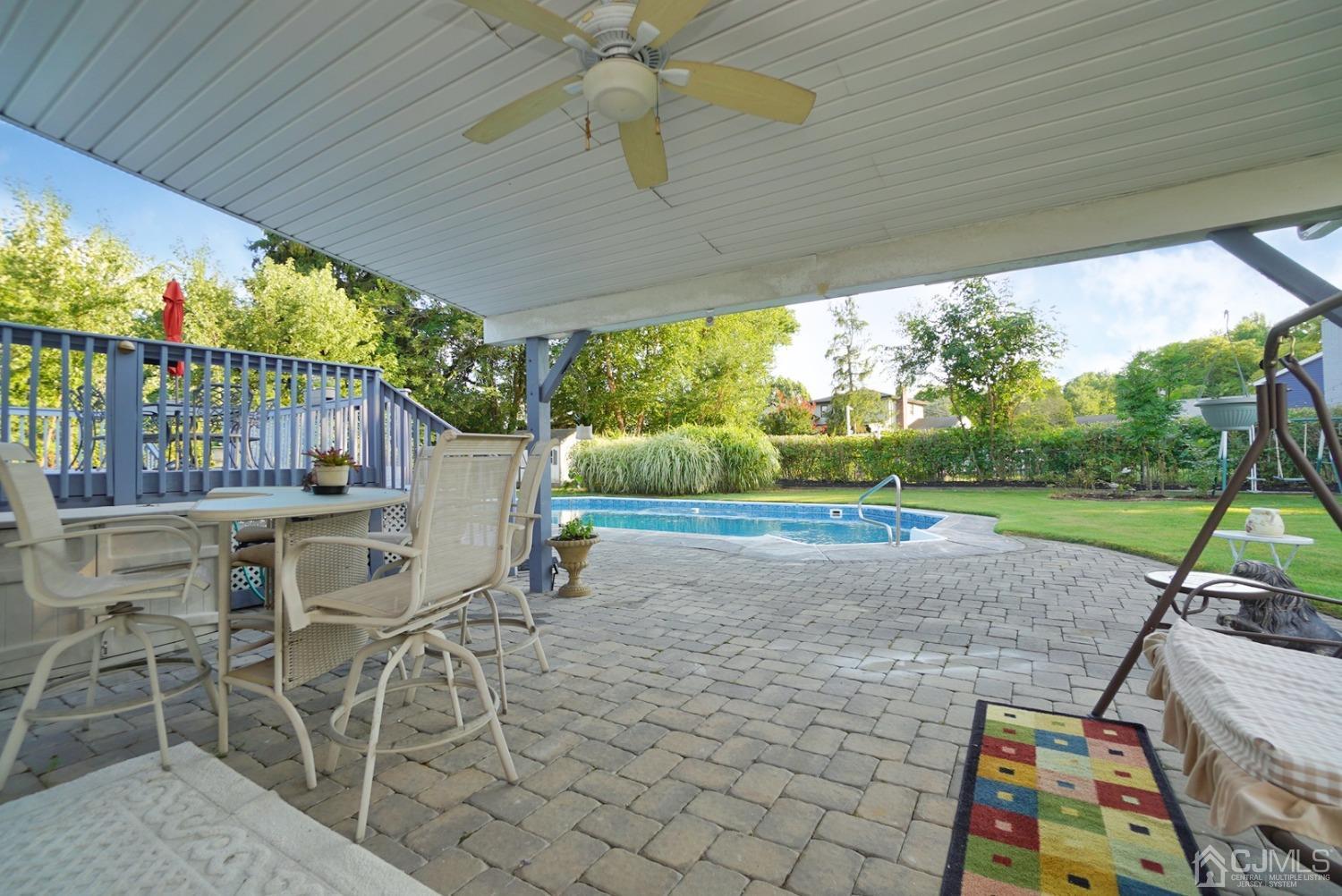 60 Annette Drive Edison, NJ 08820 - Photo 53 of 69 a view of a patio with table and chairs a barbeque with wooden fence