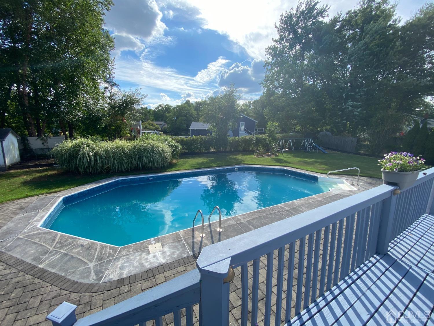 60 Annette Drive Edison, NJ 08820 - Photo 65 of 69 a view of a swimming pool and deck in the backyard