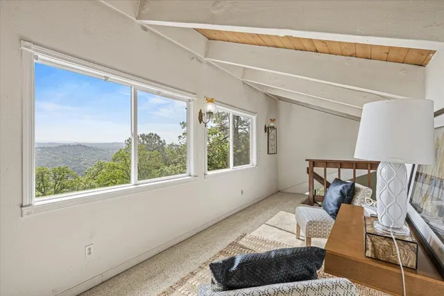 a living room with furniture a air conditioner vent and a window