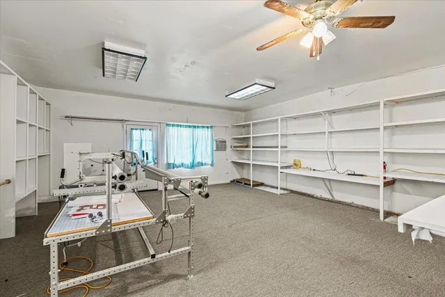 a living room with furniture and a ceiling fan