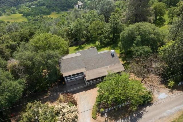 an aerial view of a house with a yard