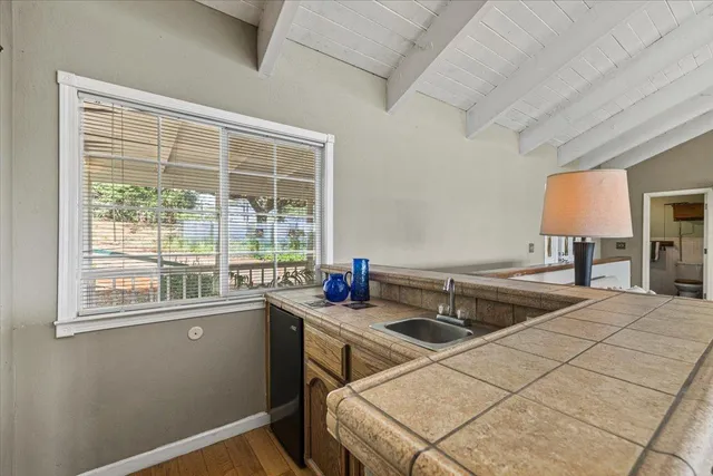 a living room with furniture and large windows