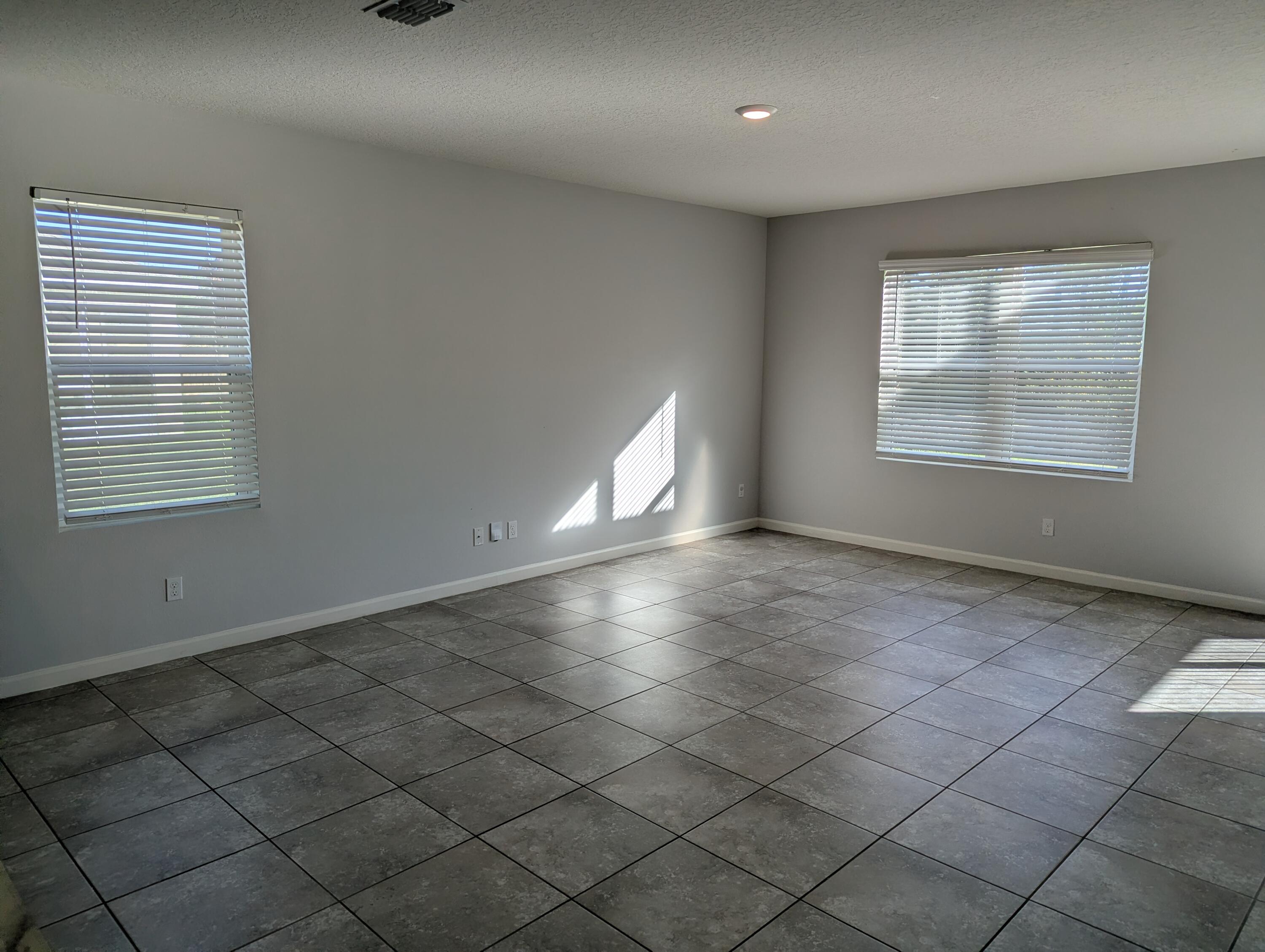 284 Southwest Ridgecrest Drive Port St. Lucie, FL 34953 - Photo 11 of 16 an empty room with windows