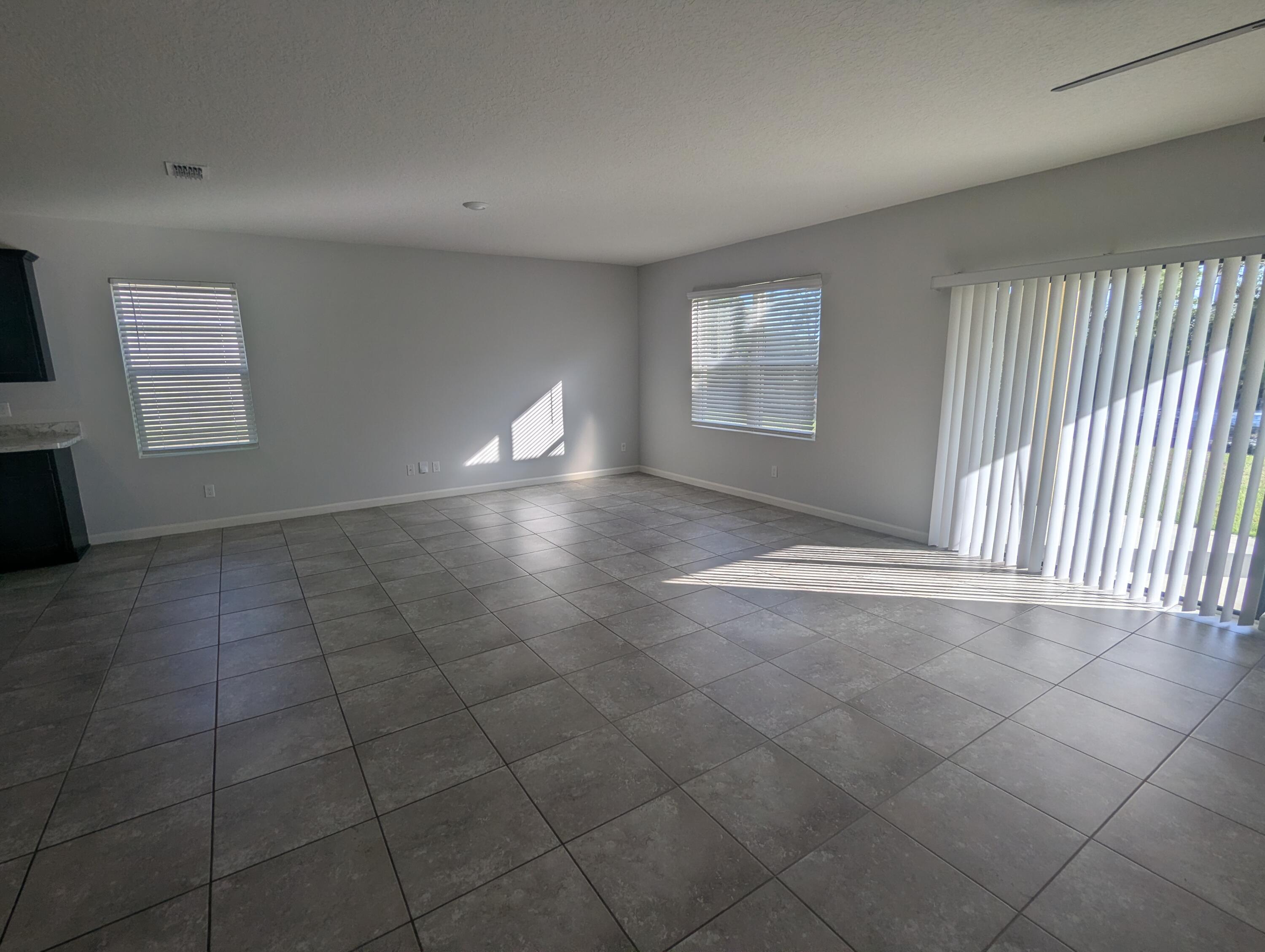 284 Southwest Ridgecrest Drive Port St. Lucie, FL 34953 - Photo 13 of 16 an empty room with windows