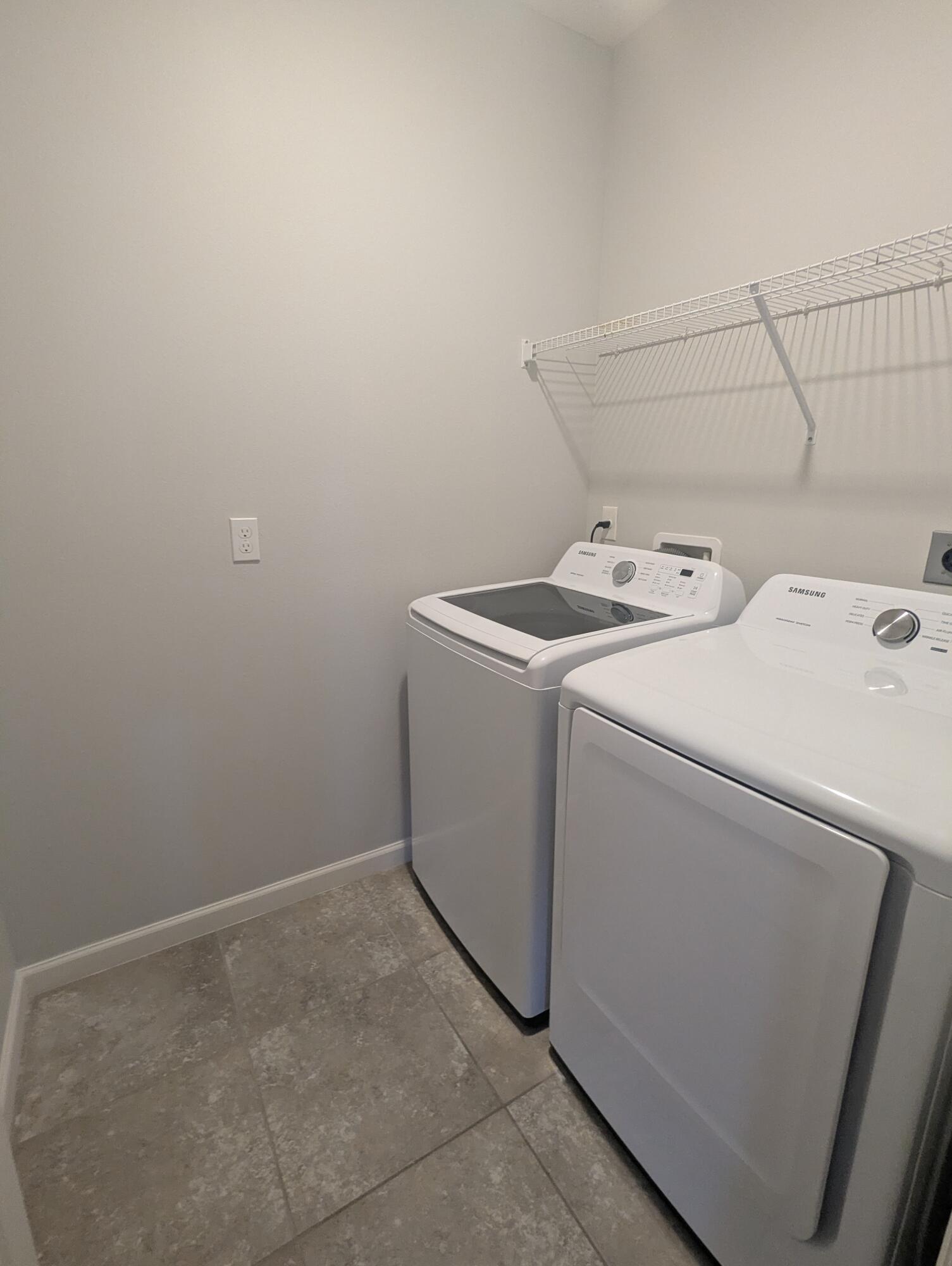 284 Southwest Ridgecrest Drive Port St. Lucie, FL 34953 - Photo 14 of 16 a utility room with dryer and washer