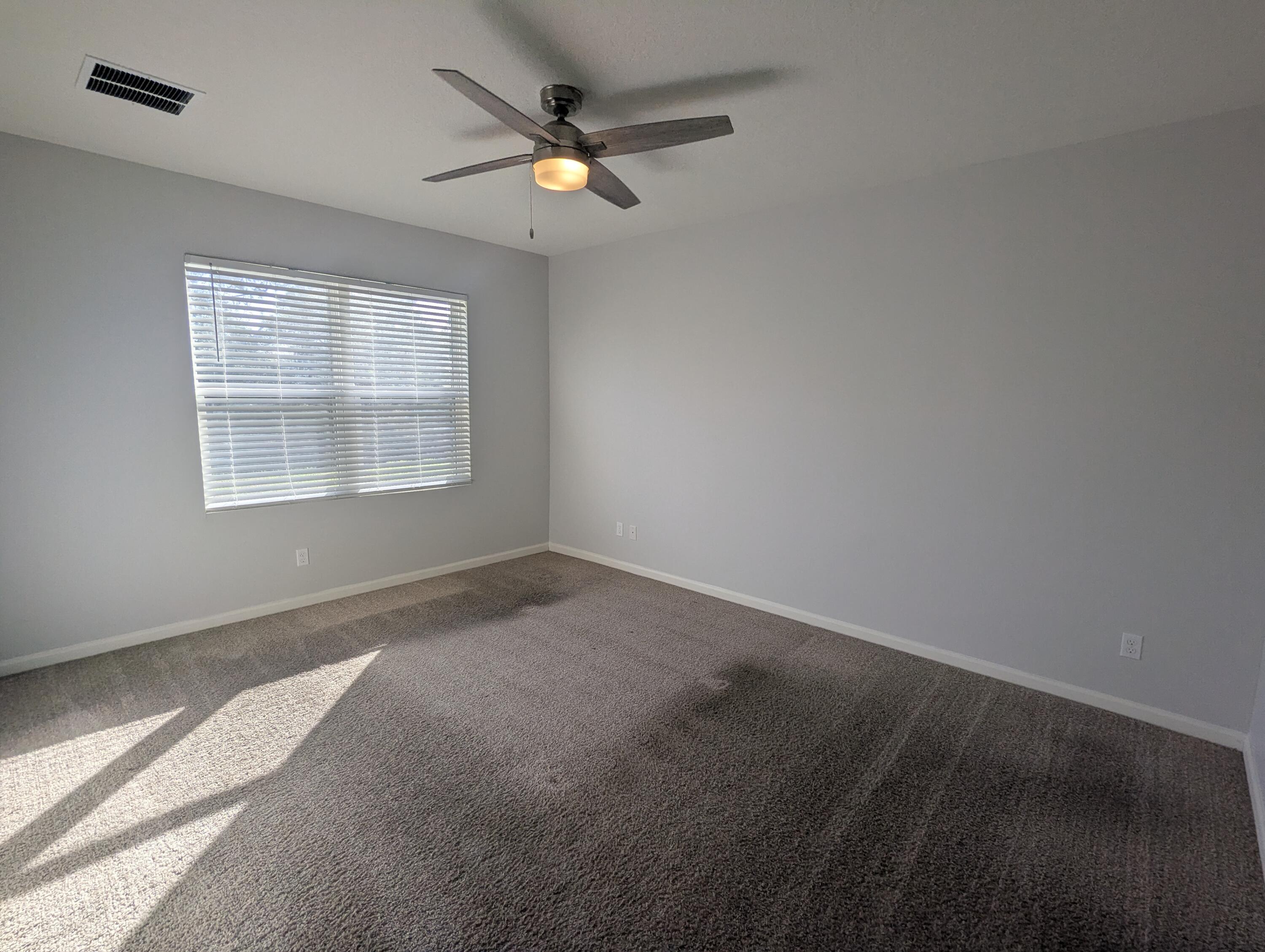 284 Southwest Ridgecrest Drive Port St. Lucie, FL 34953 - Photo 6 of 16 an empty room with windows