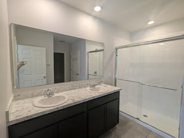 a bathroom with a granite countertop sink mirror and double