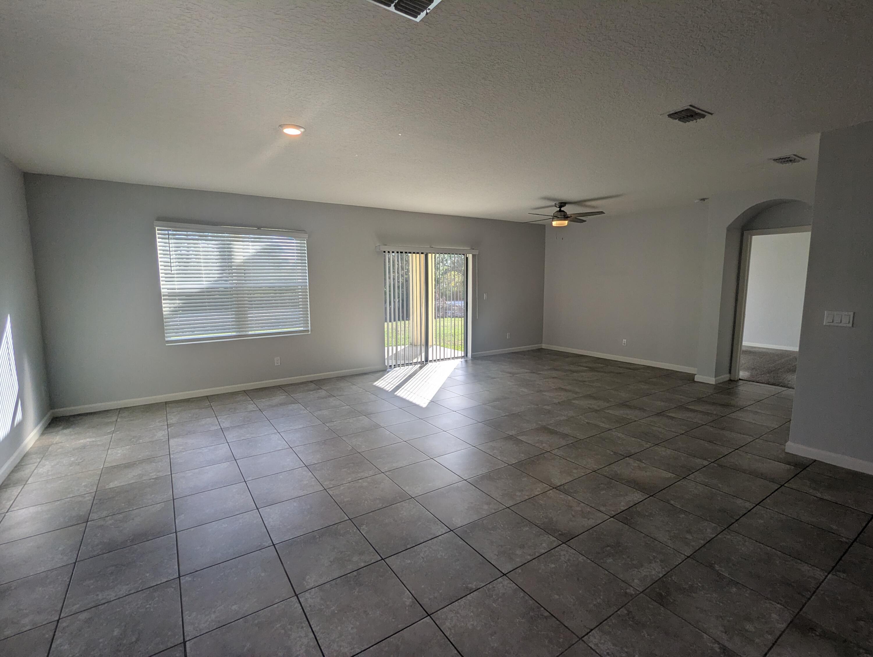 284 Southwest Ridgecrest Drive Port St. Lucie, FL 34953 - Photo 8 of 16 an empty room with windows