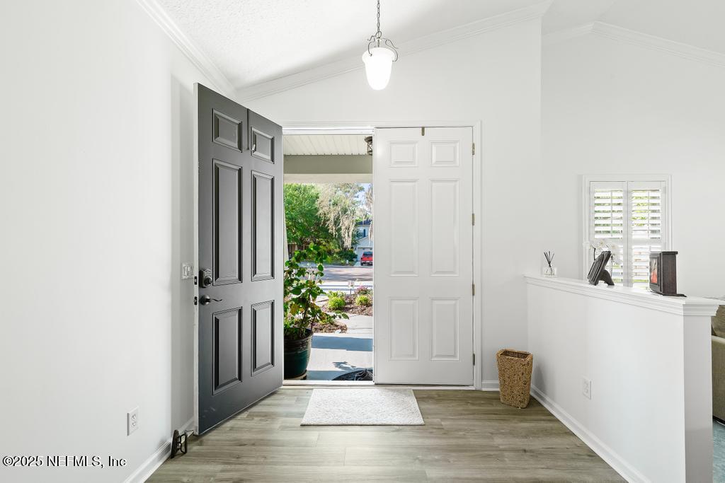 3139 Ashgrove Road Jacksonville, FL 32226 - Photo 20 of 81 a view of a hallway with wooden floor and a dining room