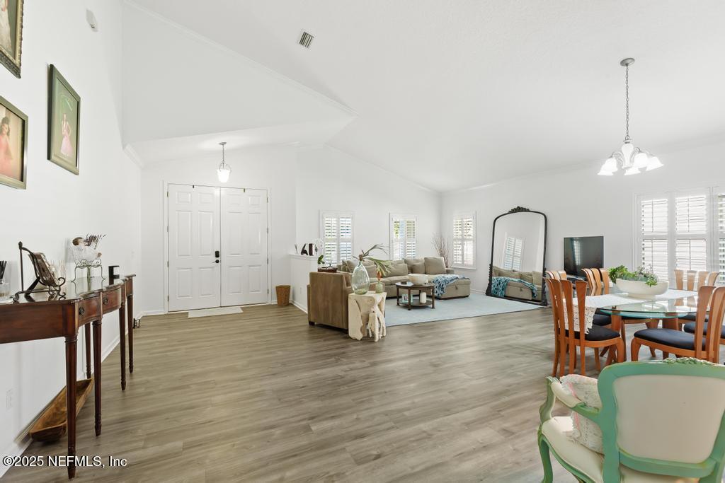 3139 Ashgrove Road Jacksonville, FL 32226 - Photo 25 of 81 a living room with furniture and a dining table with wooden floor