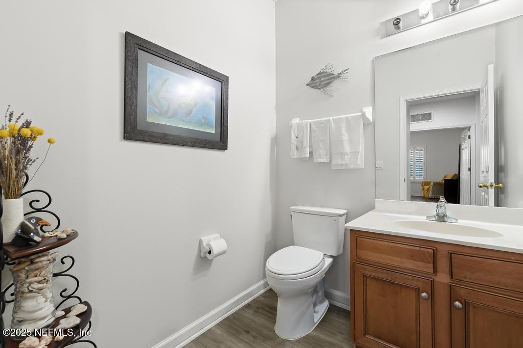 3139 Ashgrove Road Jacksonville, FL 32226 - Photo 39 of 81 a bathroom with a toilet sink and mirror