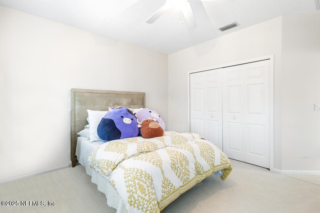 3139 Ashgrove Road Jacksonville, FL 32226 - Photo 57 of 81 a bed sitting in a bedroom next to a bathroom