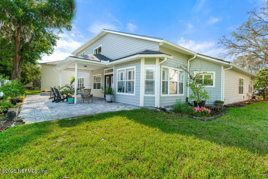 3139 Ashgrove Road Jacksonville, FL 32226 - Photo 6 of 81 a view of a house with a big yard patio and a garden