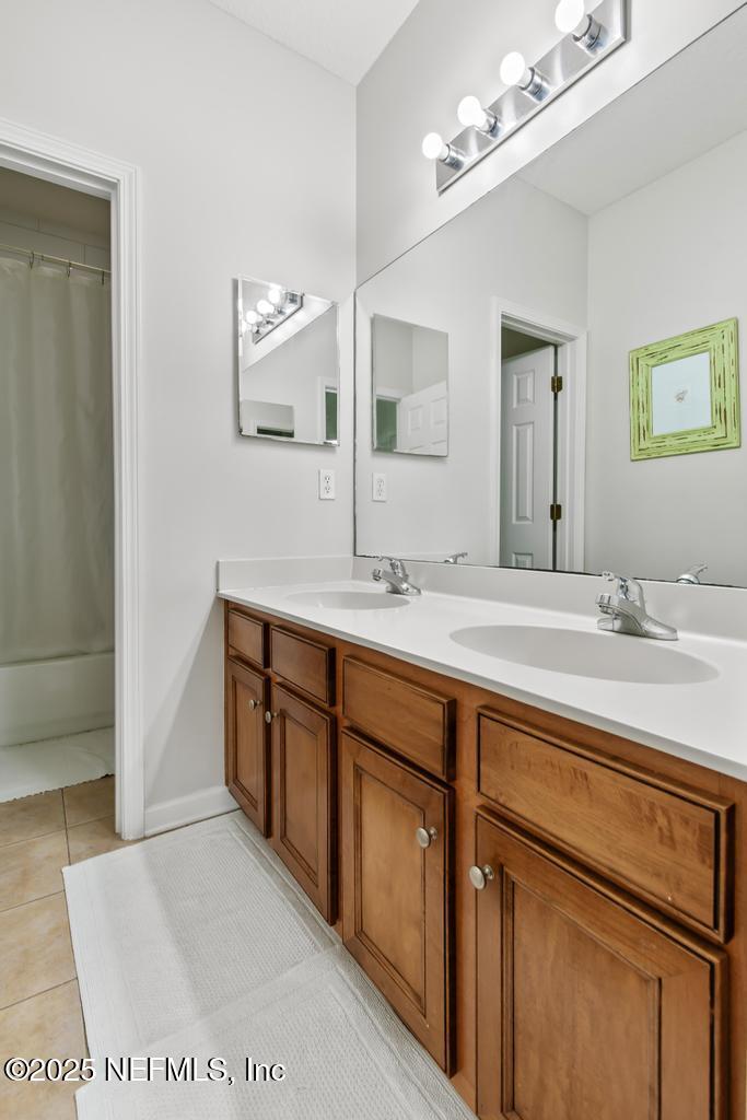 3139 Ashgrove Road Jacksonville, FL 32226 - Photo 61 of 81 a bathroom with a double vanity sink and a mirror