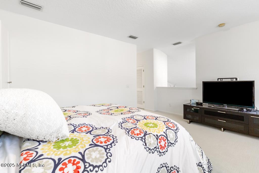 3139 Ashgrove Road Jacksonville, FL 32226 - Photo 66 of 81 a bedroom with a bed and a flat screen tv on the dresser