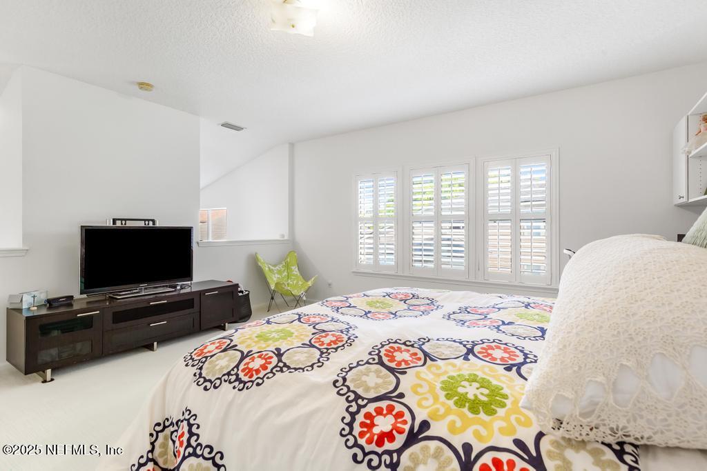 3139 Ashgrove Road Jacksonville, FL 32226 - Photo 67 of 81 a bedroom with a bed a television and a window