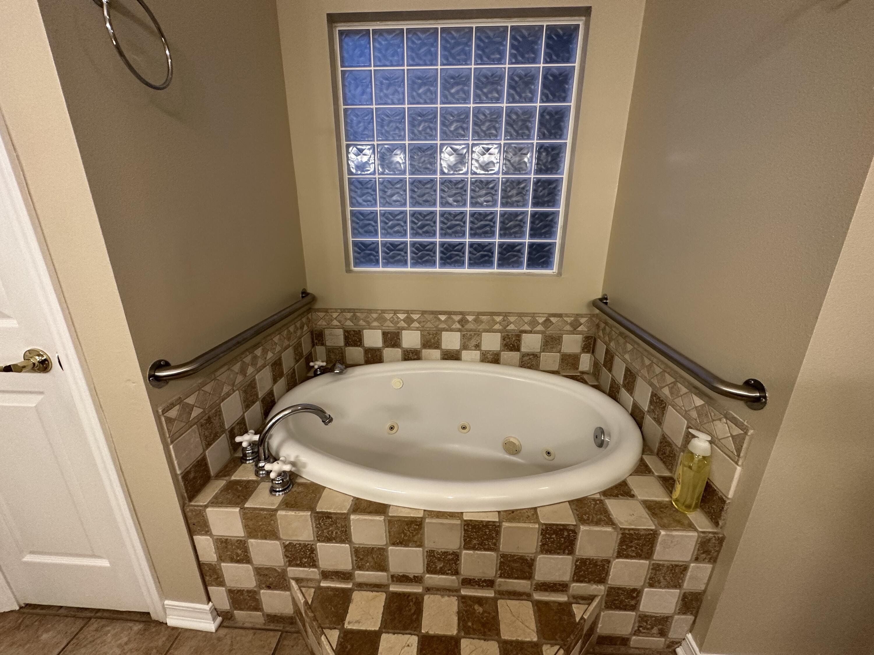 5771 Flora Lee Lane Crestview, FL 32539 - Photo 14 of 66 a bathroom with a bathtub and a shower