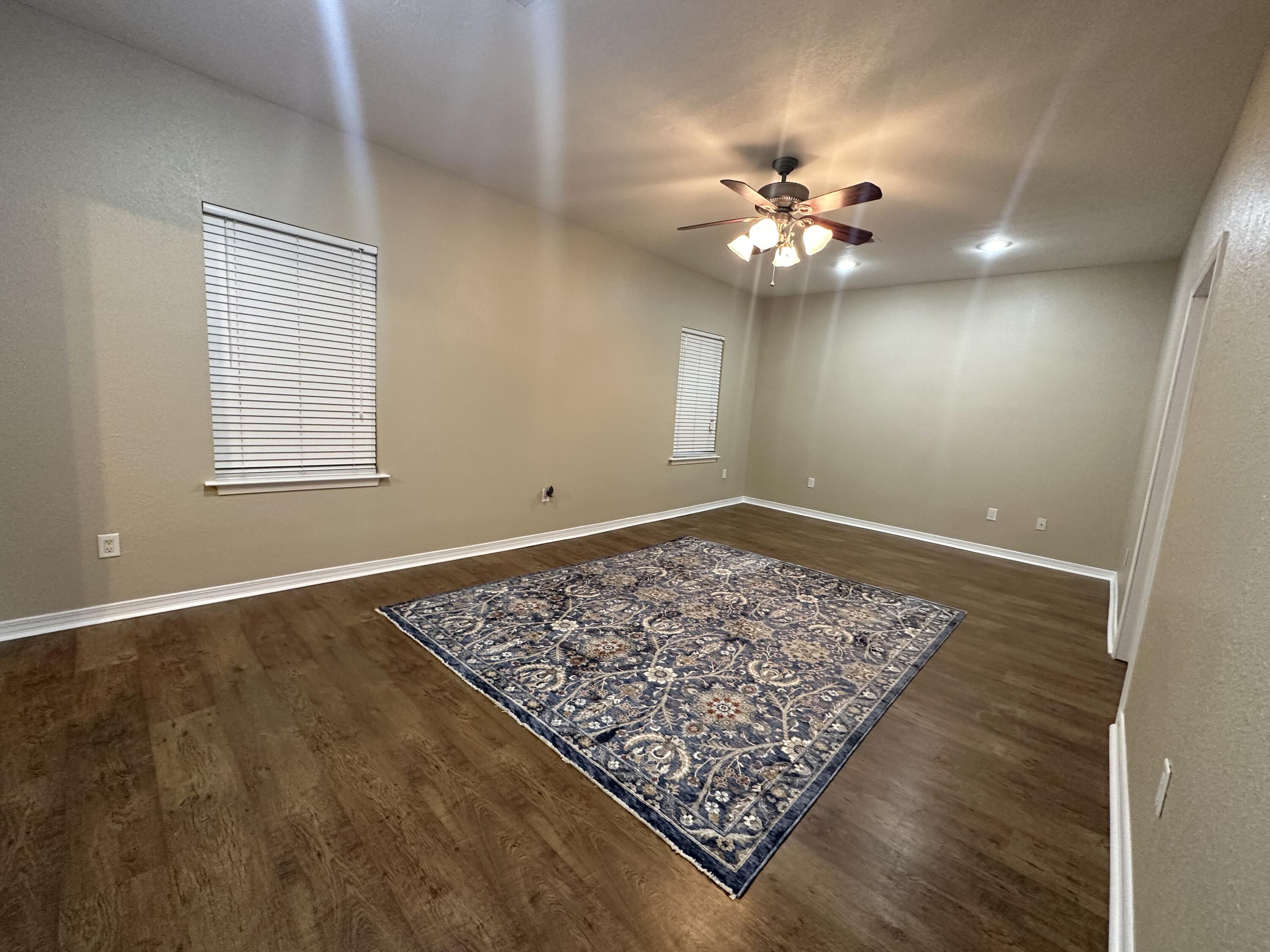 5771 Flora Lee Lane Crestview, FL 32539 - Photo 16 of 66 a view of an empty room with window and chandelier fan