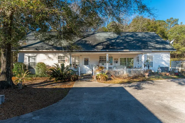 a view of a house with yard and sitting area