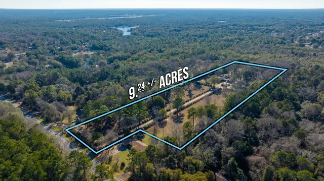 a view of a house with large trees