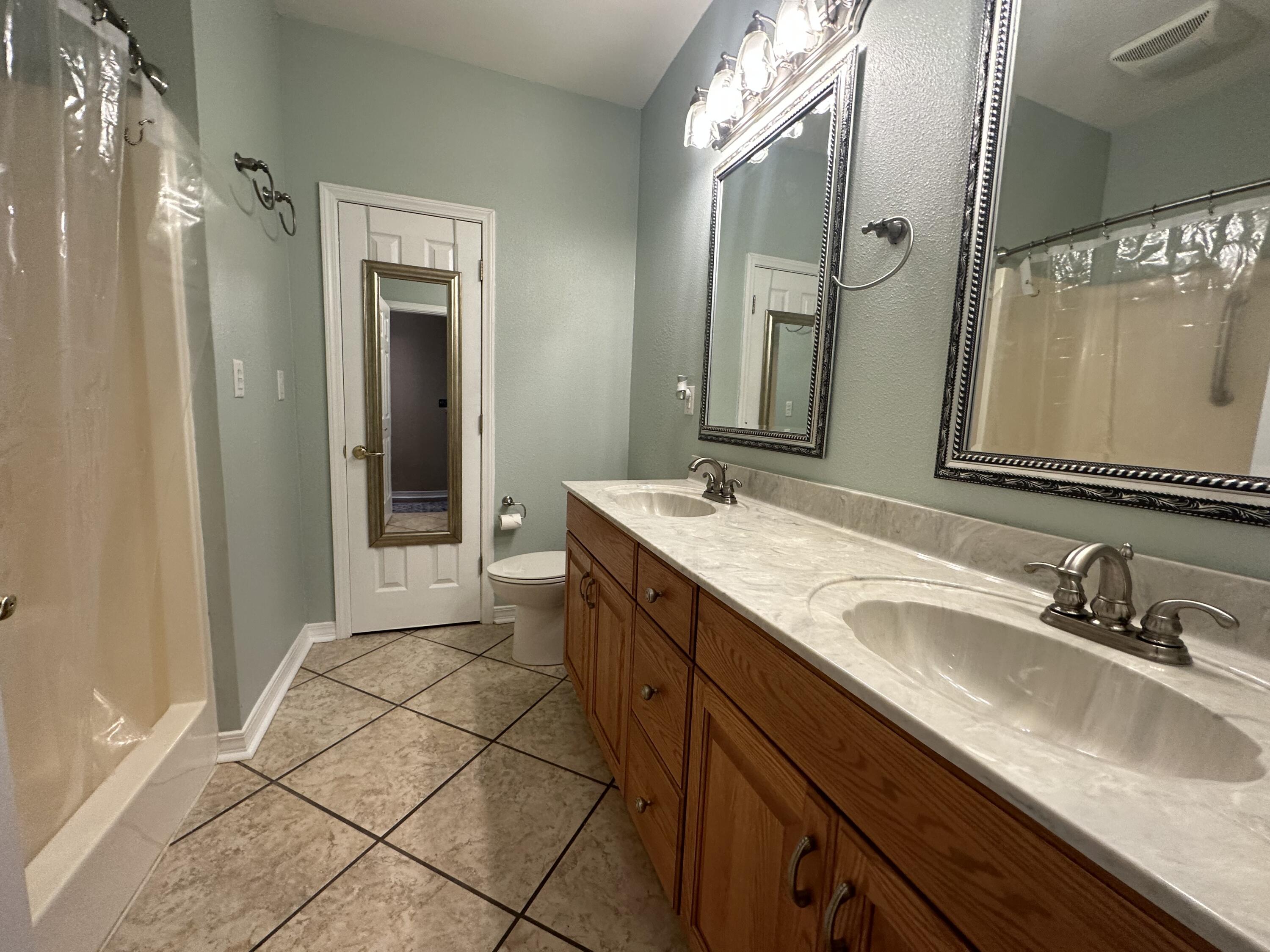 5771 Flora Lee Lane Crestview, FL 32539 - Photo 52 of 66 a bathroom with a granite countertop sink and a mirror