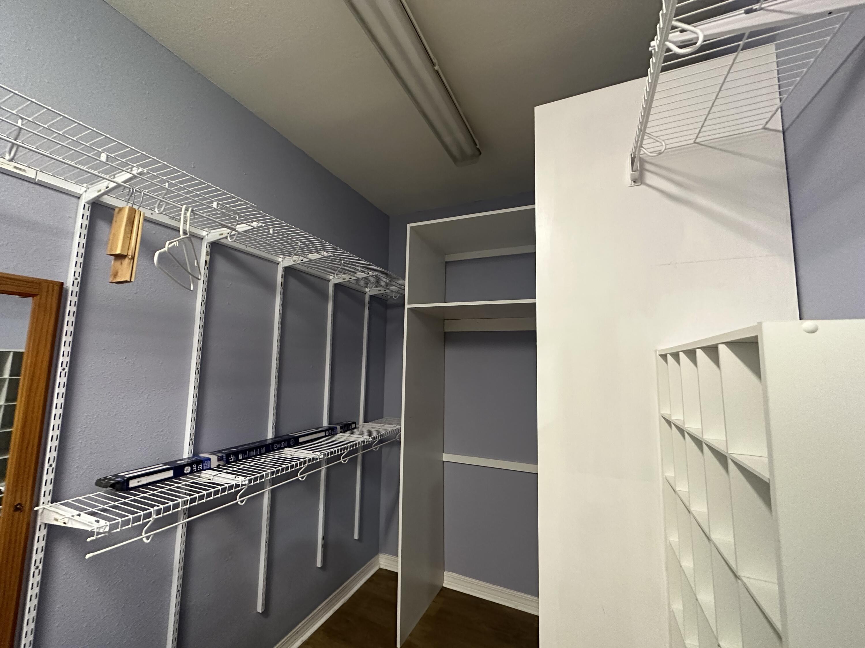 5771 Flora Lee Lane Crestview, FL 32539 - Photo 54 of 66 a view of walk in closet with clothes and shoes