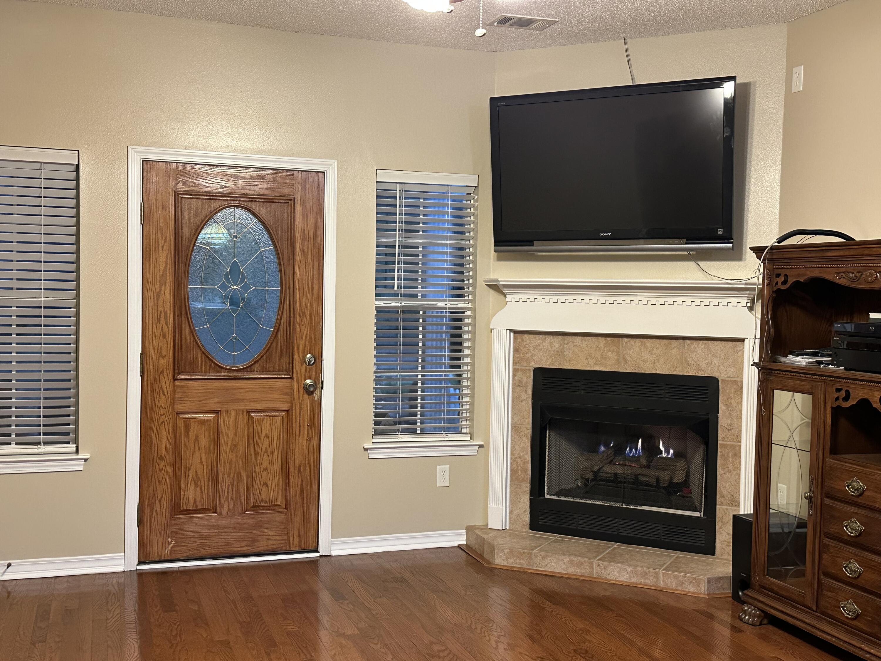 5771 Flora Lee Lane Crestview, FL 32539 - Photo 57 of 66 a living room with a fireplace and a flat screen tv