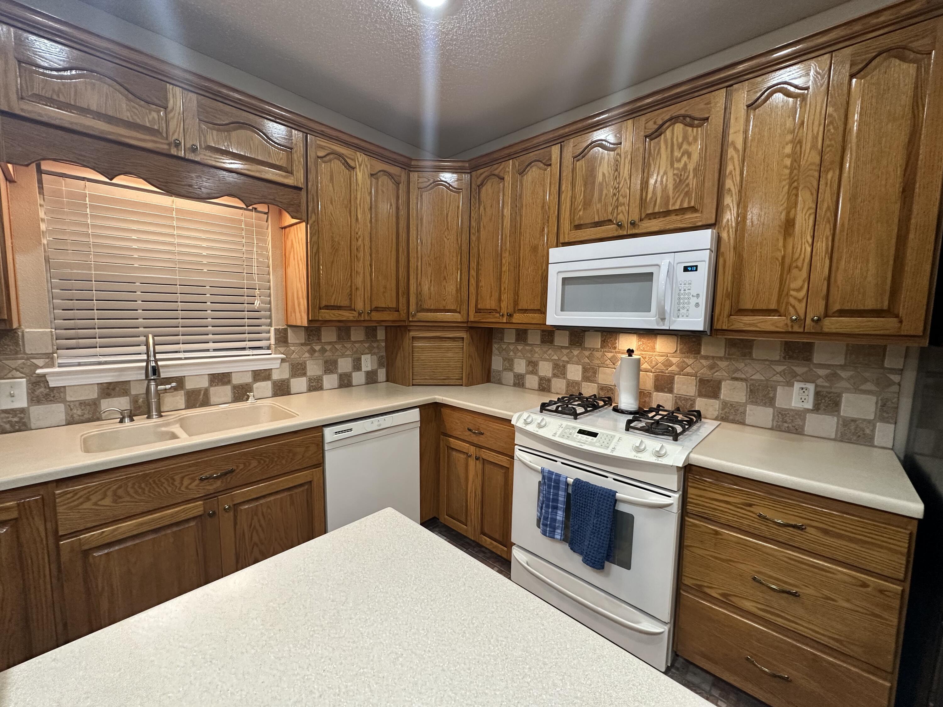 5771 Flora Lee Lane Crestview, FL 32539 - Photo 59 of 66 a kitchen with a sink stove and microwave