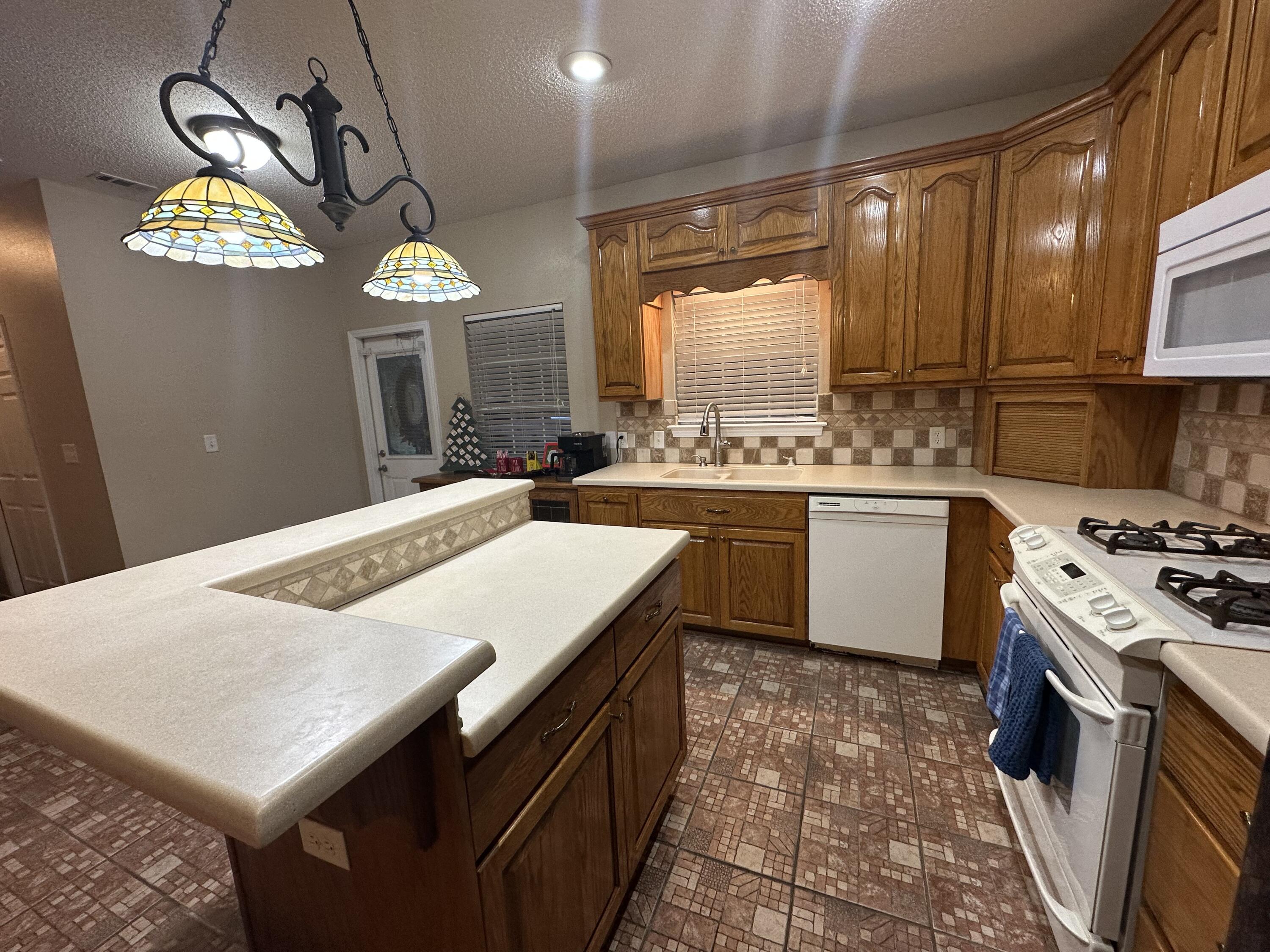 5771 Flora Lee Lane Crestview, FL 32539 - Photo 8 of 66 a kitchen with a stove a sink a kitchen island a stove and a refrigerator