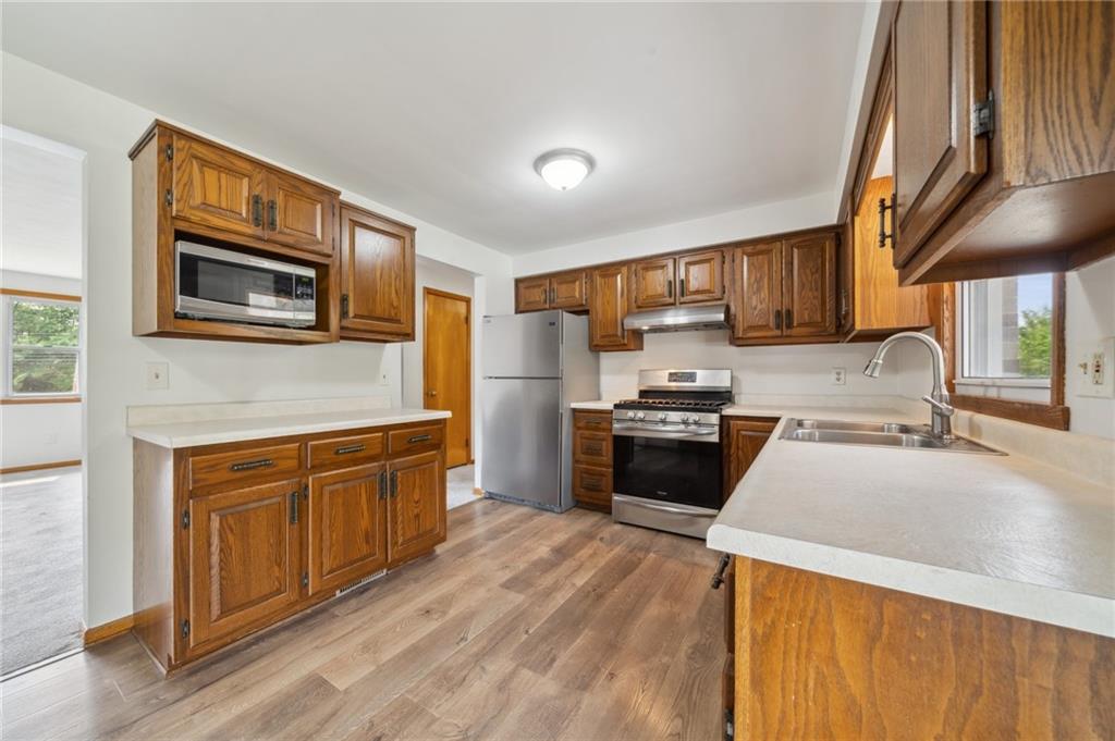 331 East Union Road Cheswick, PA 15024 - Photo 6 of 26 a large kitchen with stainless steel appliances granite countertop a stove a sink dishwasher and a microwave oven with white cabinets