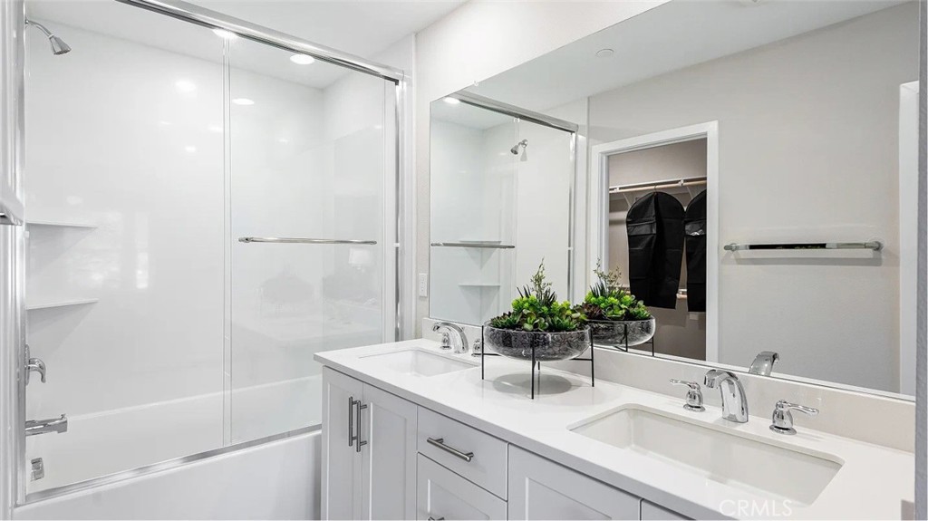 8451 Tapia Way Rancho Cucamonga, CA 91730 - Photo 16 of 26 a bathroom with a granite countertop sink and a mirror