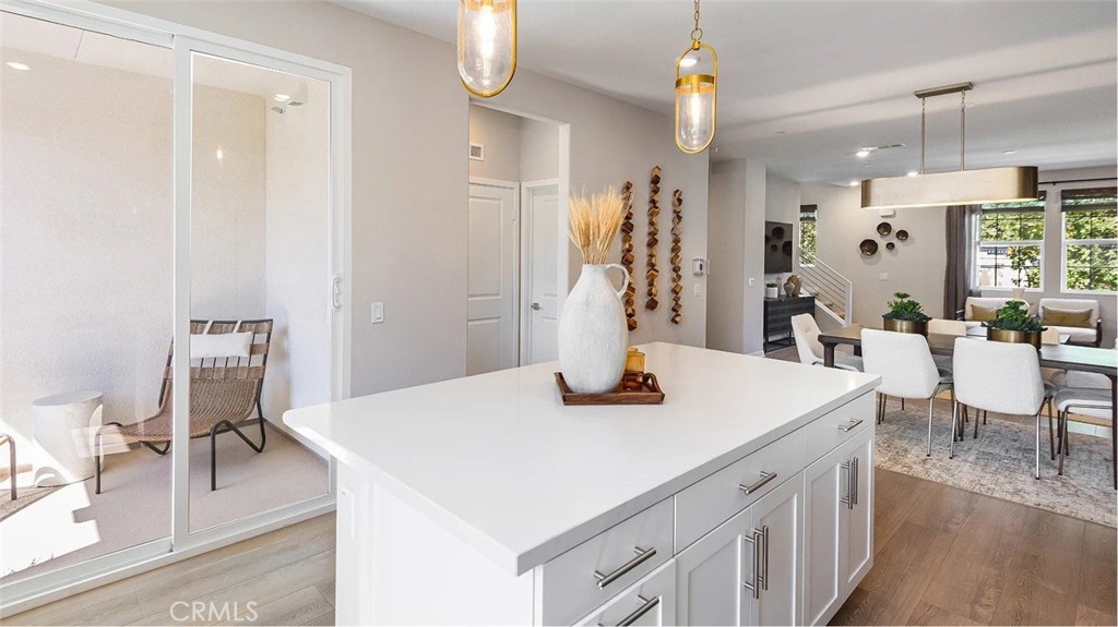 8451 Tapia Way Rancho Cucamonga, CA 91730 - Photo 5 of 26 a view of kitchen island dining table and wooden floor
