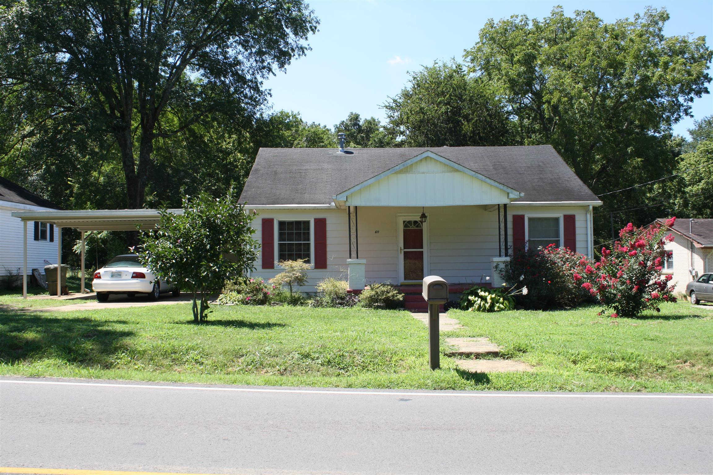 611 Fall River Road Lawrenceburg, TN 38464 - Photo 1 of 18 a front view of a house with a yard and garage