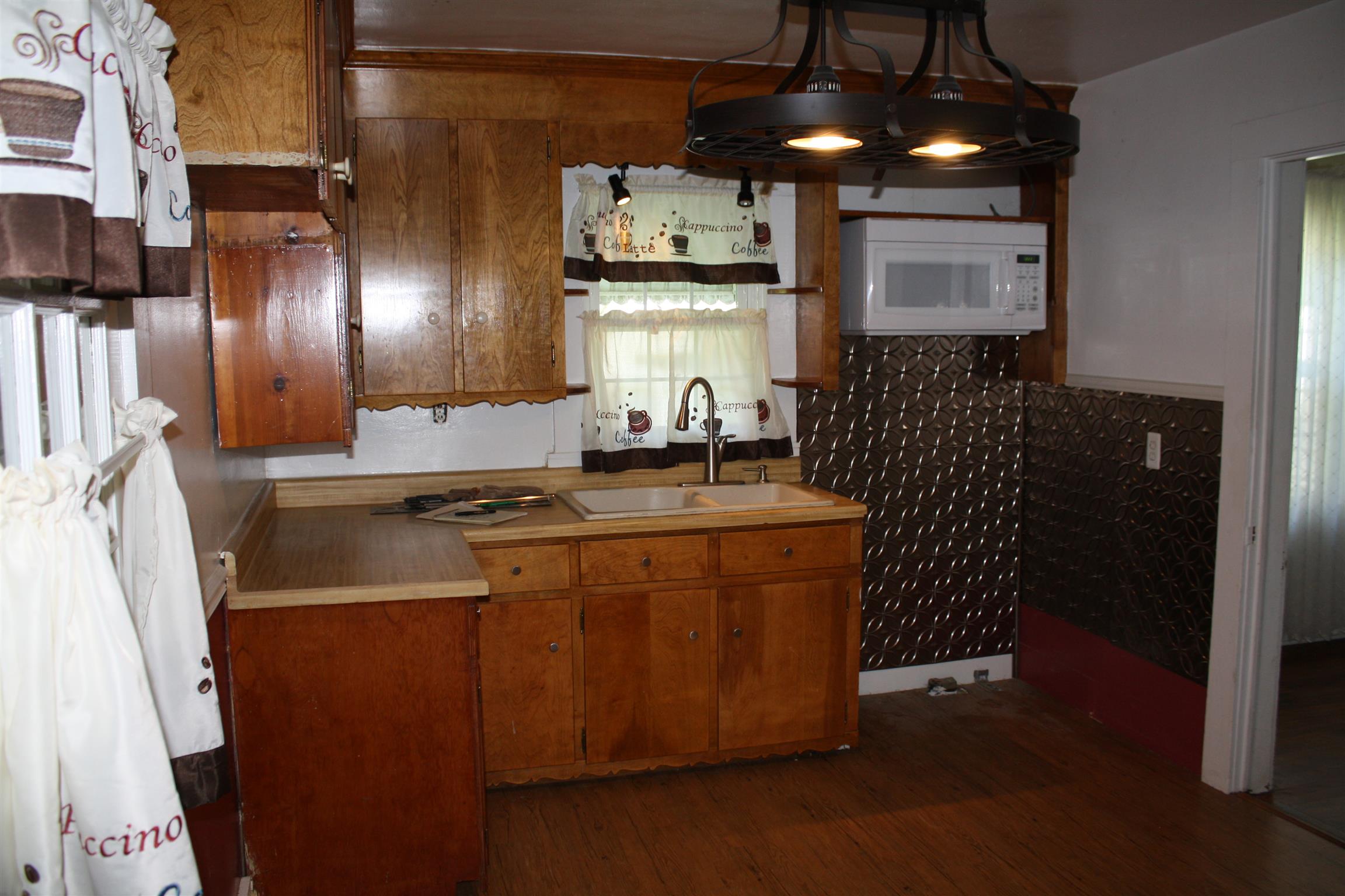 611 Fall River Road Lawrenceburg, TN 38464 - Photo 8 of 18 a kitchen with stainless steel appliances granite countertop a sink a stove and a refrigerator