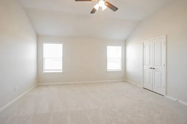 an empty room with a empty space and a ceiling fan