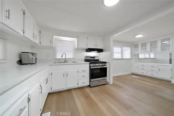 a kitchen with granite countertop a sink and steel appliances