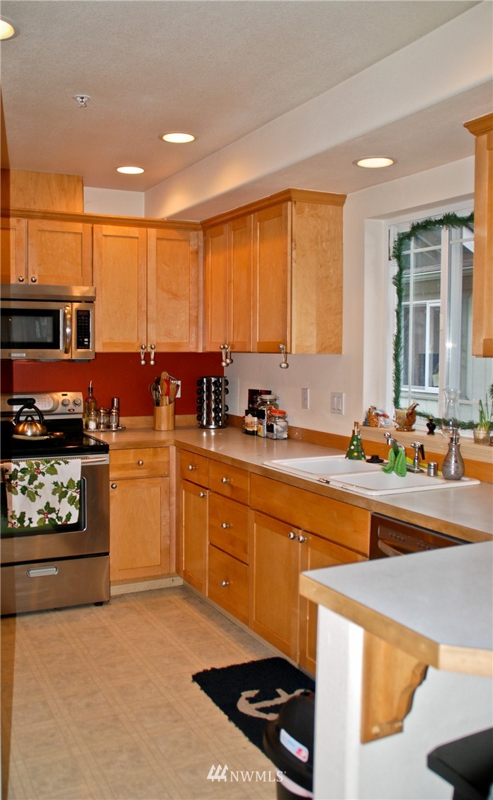 3120 12th Street Everett, WA 98201 - Photo 2 of 12 a kitchen with stainless steel appliances kitchen island granite countertop a stove a sink and a refrigerator
