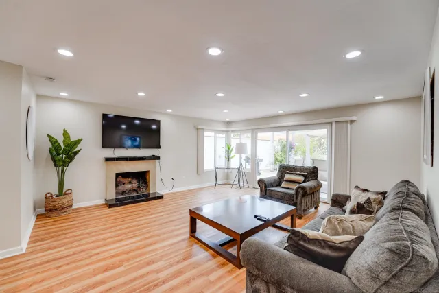 a living room with furniture a fireplace and a flat screen tv