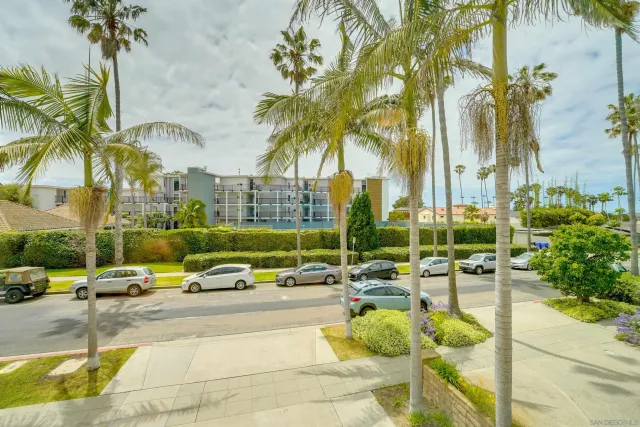 a view of swimming pool with lawn chairs under an umbrella