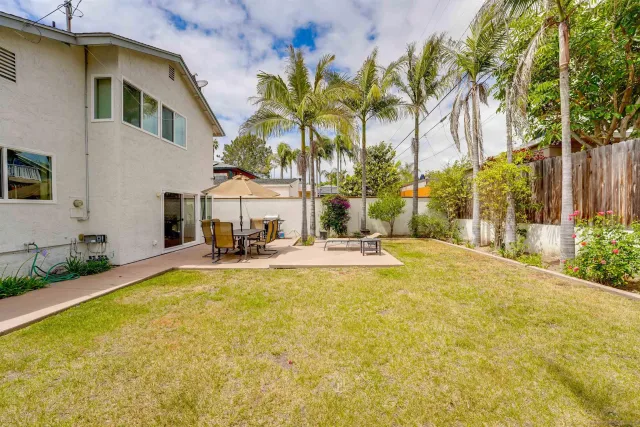 a view of a house with swimming pool and sitting area